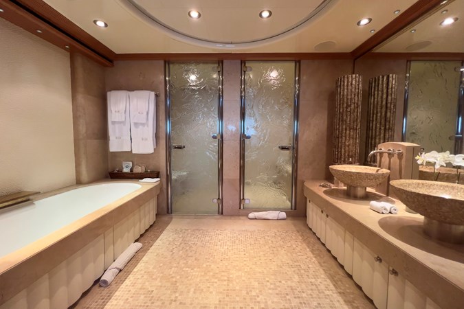 The bathroom with a steam room as well as a bath
