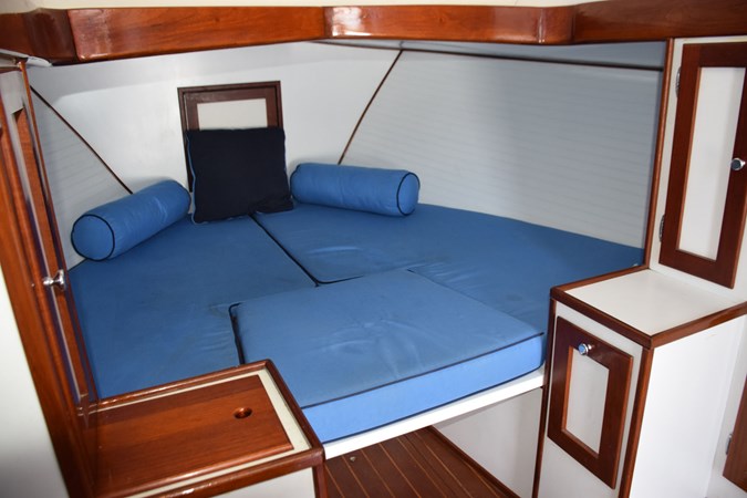 Open V-berth with filler cushion, wood trim
