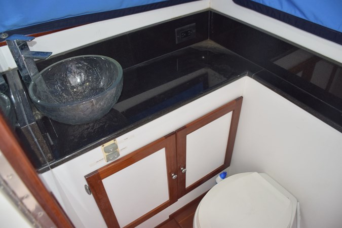 Head with granite vanity, backsplash, and basin sink