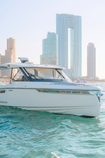 ICE 4 Front view of Saxdor 400 GTO ICE yacht cruising in Dubai waters with city skyline in background.