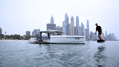 ICE 6 Starboard side view of Saxdor 400 GTO ICE yacht underway in Dubai with modern skyscrapers in background.