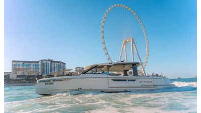 ICE 8 Saxdor 400 GTO ICE yacht cruising in Dubai Marina with Ain Dubai Ferris Wheel in the background.