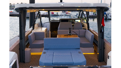 ICE 15 Saxdor 400 GTO ICE cockpit lounge with wraparound seating, wooden dining table, and panoramic Dubai Marina skyline views.
