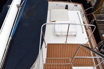 JAMIE LYN 5 1997 Grand Banks Classic yacht deck with wooden flooring and safety railings.