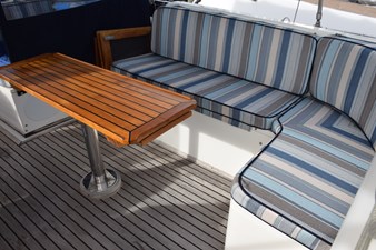 JAMIE LYN 6 1997 Grand Banks Classic yacht interior with striped seating and wooden table.