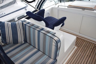 JAMIE LYN 8 1997 Grand Banks Classic yacht interior with striped seating and wooden flooring.