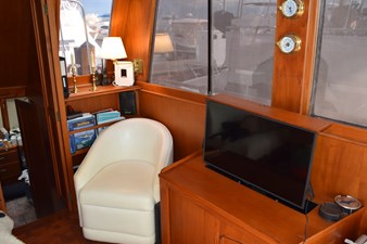 JAMIE LYN 15 Interior of 1997 Grand Banks Classic yacht with chair, TV, and nautical decor.