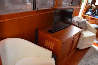 JAMIE LYN 18 Interior of 1997 Grand Banks Classic yacht with TV and white chairs.