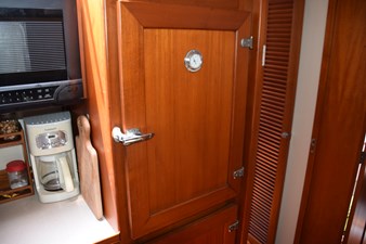 JAMIE LYN 24 1997 Grand Banks Classic interior with wooden cabinetry, microwave, and coffee maker.