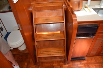 JAMIE LYN 26 Wooden interior stairs and cabinetry in a 1997 Grand Banks Classic yacht.