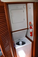 JAMIE LYN 30 Laundry area with washer and dryer on 1997 Grand Banks Classic boat.