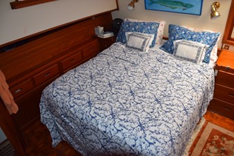 JAMIE LYN 32 Cozy bedroom in 1997 Grand Banks Classic yacht with nautical decor and wooden cabinetry.