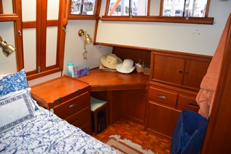 JAMIE LYN 33 Cozy cabin interior of 1997 Grand Banks Classic yacht with wooden furnishings and nautical decor.