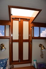 JAMIE LYN 36 Interior of 1997 Grand Banks Classic yacht with wooden hatch and brass lighting.