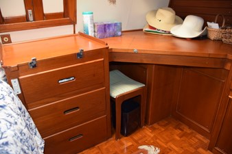 JAMIE LYN 37 1997 Grand Banks Classic interior with wooden cabinetry and desk, featuring hats and storage (1)