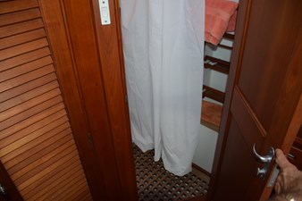 JAMIE LYN 40 Interior of 1997 Grand Banks Classic yacht with wooden doors and white curtain.