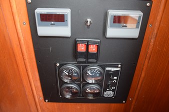 JAMIE LYN 46 Control panel of a 1997 Grand Banks Classic boat with gauges and switches.