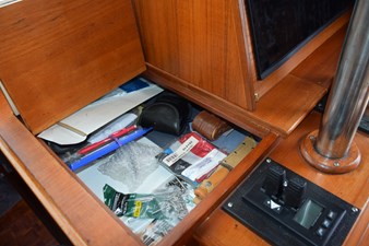 JAMIE LYN 50 Interior storage compartment on a 1997 Grand Banks Classic boat with various items.