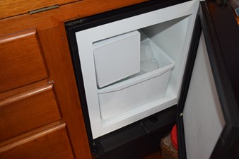 JAMIE LYN 52 Ice maker inside a 1997 Grand Banks Classic boat's wooden cabinet.