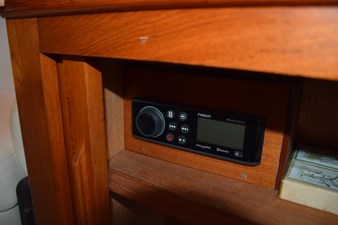 JAMIE LYN 53 1997 Grand Banks Classic interior with Fusion audio system installed in wooden cabinet.