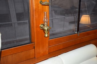 JAMIE LYN 56 Interior of 1997 Grand Banks Classic yacht with brass oil lamp and wooden paneling.