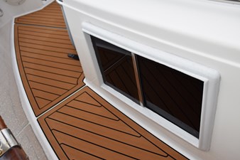 JAMIE LYN 59 1997 Grand Banks Classic boat deck with teak flooring and window detail.