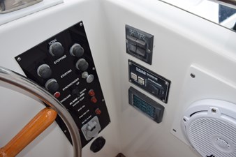 JAMIE LYN 69 1997 Grand Banks Classic boat control panel with steering wheel and marine equipment.
