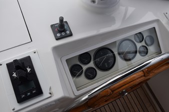 JAMIE LYN 71 Control panel of a 1997 Grand Banks Classic boat with gauges and switches.