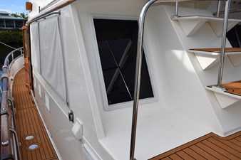 JAMIE LYN 80 1997 Grand Banks Classic yacht deck with wooden flooring and metal railings.