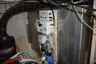 JAMIE LYN 82 Engine room of a 1997 Grand Banks Classic boat with water filtration system.