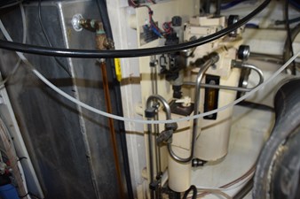 JAMIE LYN 84 Engine room of a 1997 Grand Banks Classic boat, showcasing mechanical components and wiring.