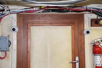 JAMIE LYN 91 Wooden door with security cameras on a 1997 Grand Banks Classic boat.