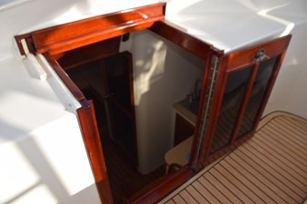 OSPREY 30 Locking entry door to cabin, teak and glass folding door with keeper and slide back solid top panel.