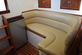 OSPREY 35 L-shape settee and refrigerator. Small cabinet storage above