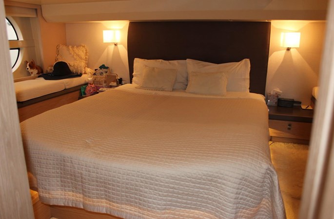 Interior view of master cabin on Monte Carlo, featuring warm wall lights 