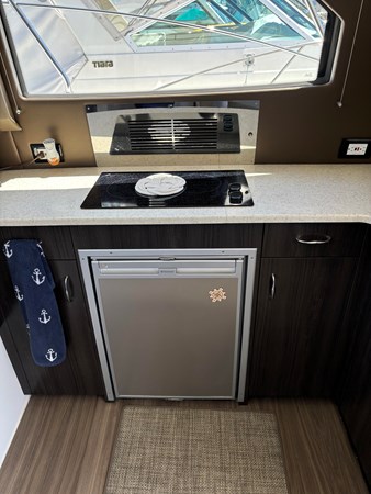 Refrigerator under the stove.