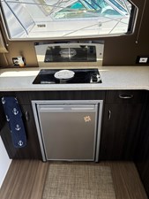 Refrigerator under the stove.