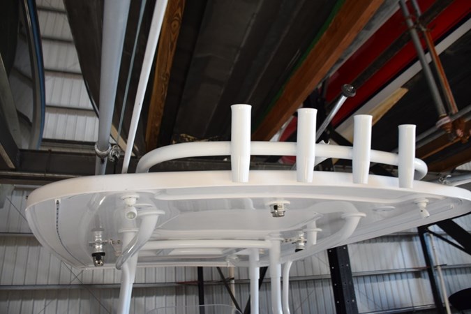 Fishing rod storage on aft hardtop, crank adjustable anchorsteaming light, LED spreader lights, white powder coated metal supports