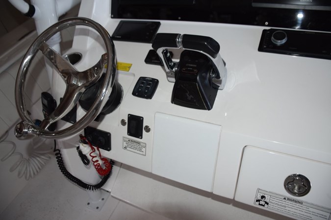 Tiltable helm wheel Yamaha control binnacle and digital engine display, bow thruster and trim tab controls.