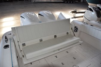 Rear seat opened, there is a receiver on deck to move fiberglass table here if wanted. Note pop-up cleats.