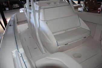 Seat on front of console with built in cooler beneath seat.