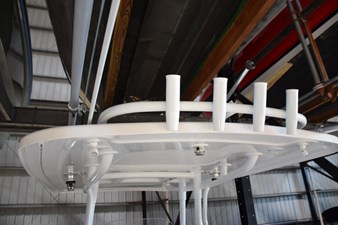 Fishing rod storage on aft hardtop, crank adjustable anchorsteaming light, LED spreader lights, white powder coated metal supports