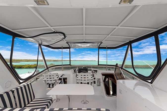 Flybridge with cabinet to starboard with drink refrigerator and sink