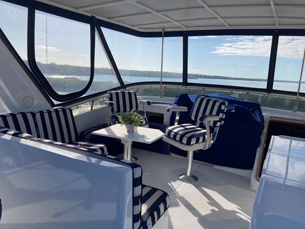Flybridge Seating and hatch open to stairs down to pilothouse
