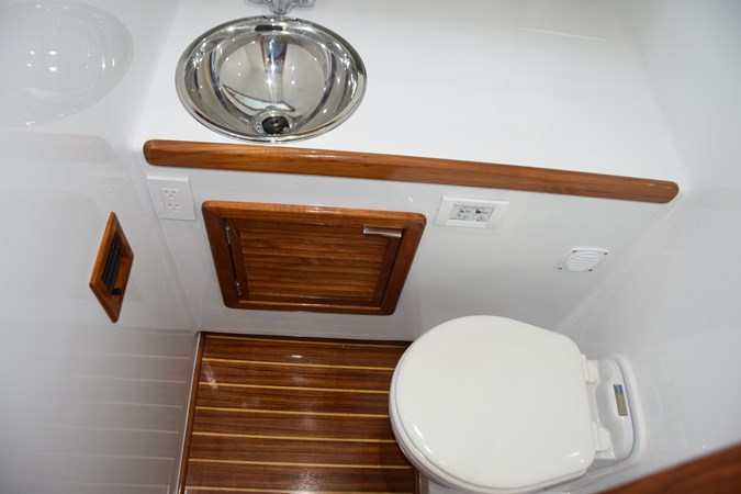 Head compartment, freshwater toilet, stainless sink.