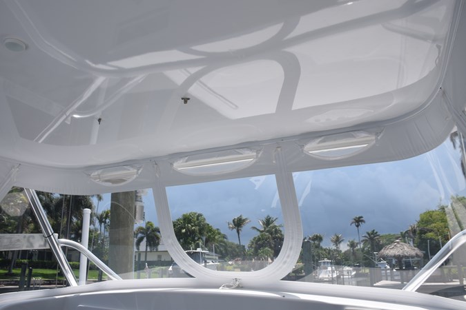 Enclosure with screened vent openings and center U-zip panel can be pinned open onto hardtop