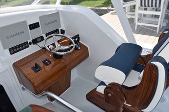 Helm console with seat bolster raised