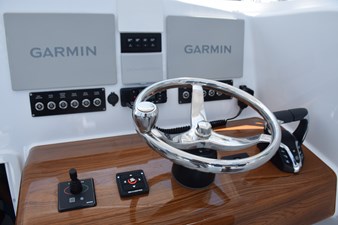 Helm has Garmin screens, gyro control panel, Vhf, thruster jogstick, Seakeeper Ride panel