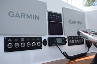Helm with Bocatech switches, Garmin MFDs, Vhf radio, 12v charging, SeaKeeper gyro display