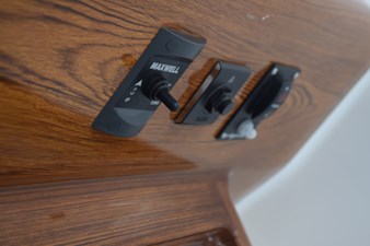 Beneath helm console, windlass remote control and engine shut off switch tether button